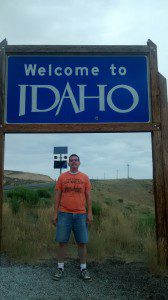 a man standing under a sign