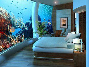 a room with a bed and fish tank
