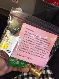 a bag of candy with a pink paper and a note