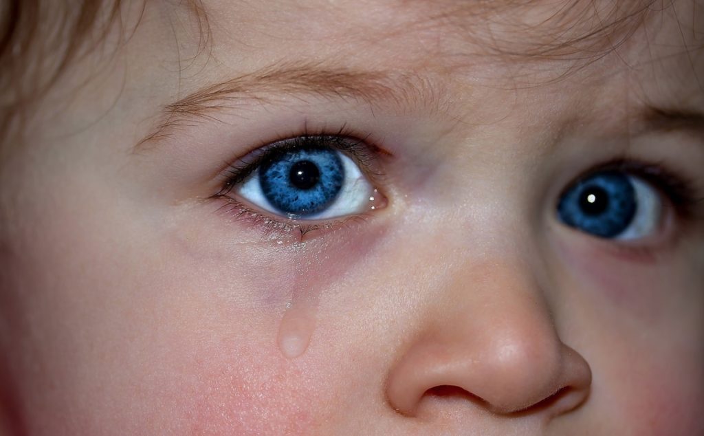 a close up of a crying child