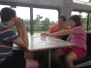 My family playing cards on an Amtrak train in the lounge car