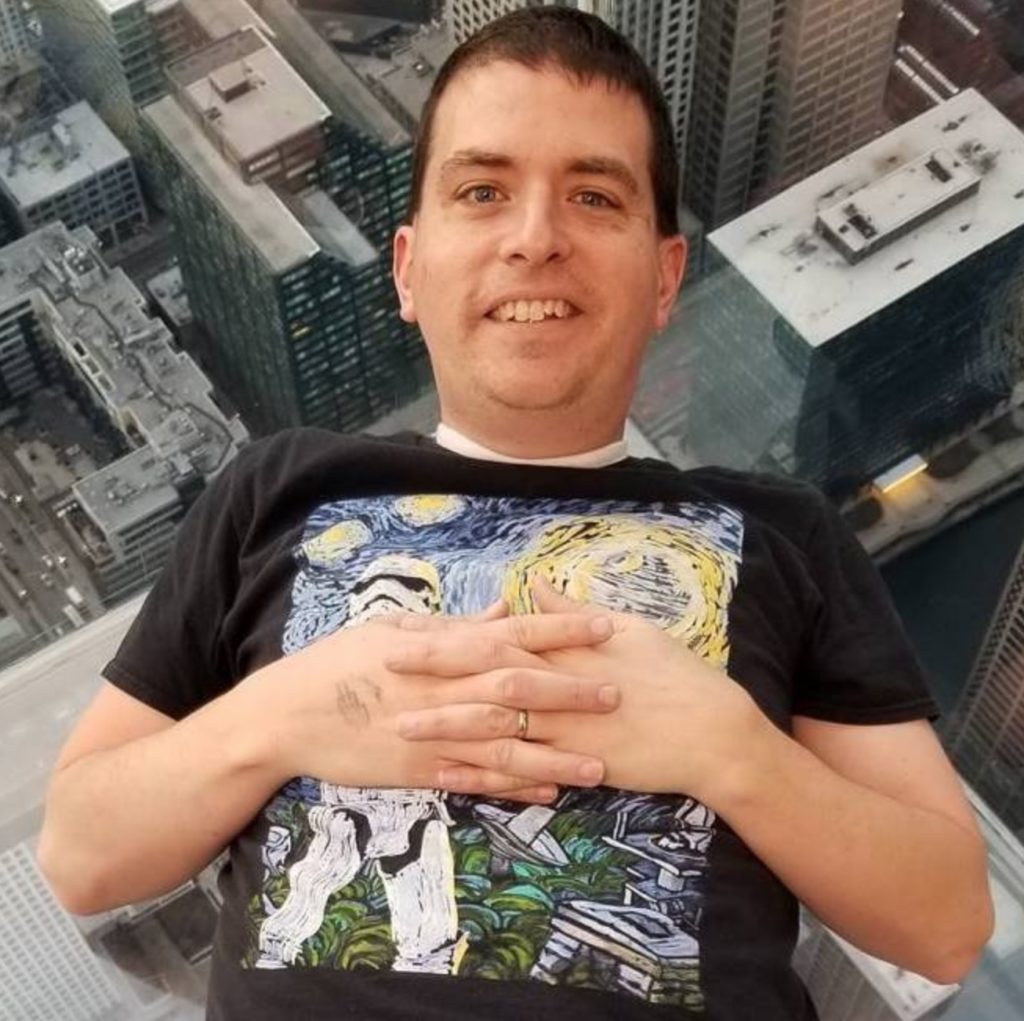 a man standing on a high rise building with his hands on his chest