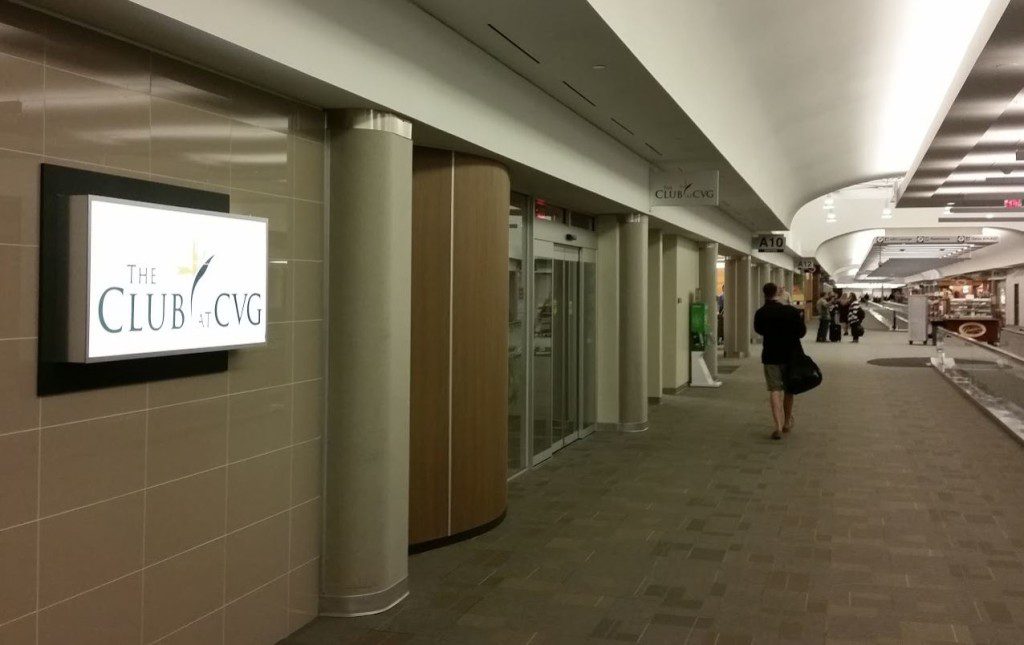 a long hallway with a sign and people walking