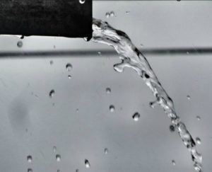 water pouring out of a pipe