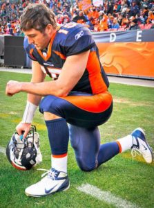 a football player kneeling on the ground