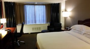 a hotel room with a bed and a chair