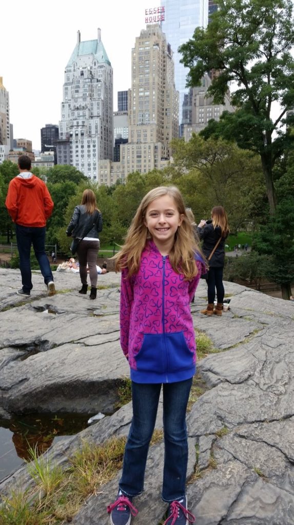 a girl standing on a rock