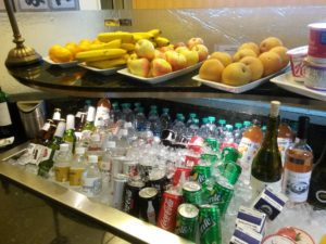 a group of fruit and drinks on a counter