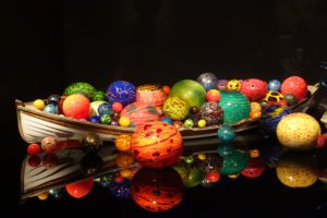 a group of colorful balls on a black surface