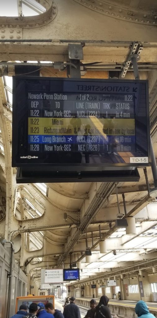 a digital screen with a train schedule