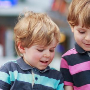 two young boys in striped shirts