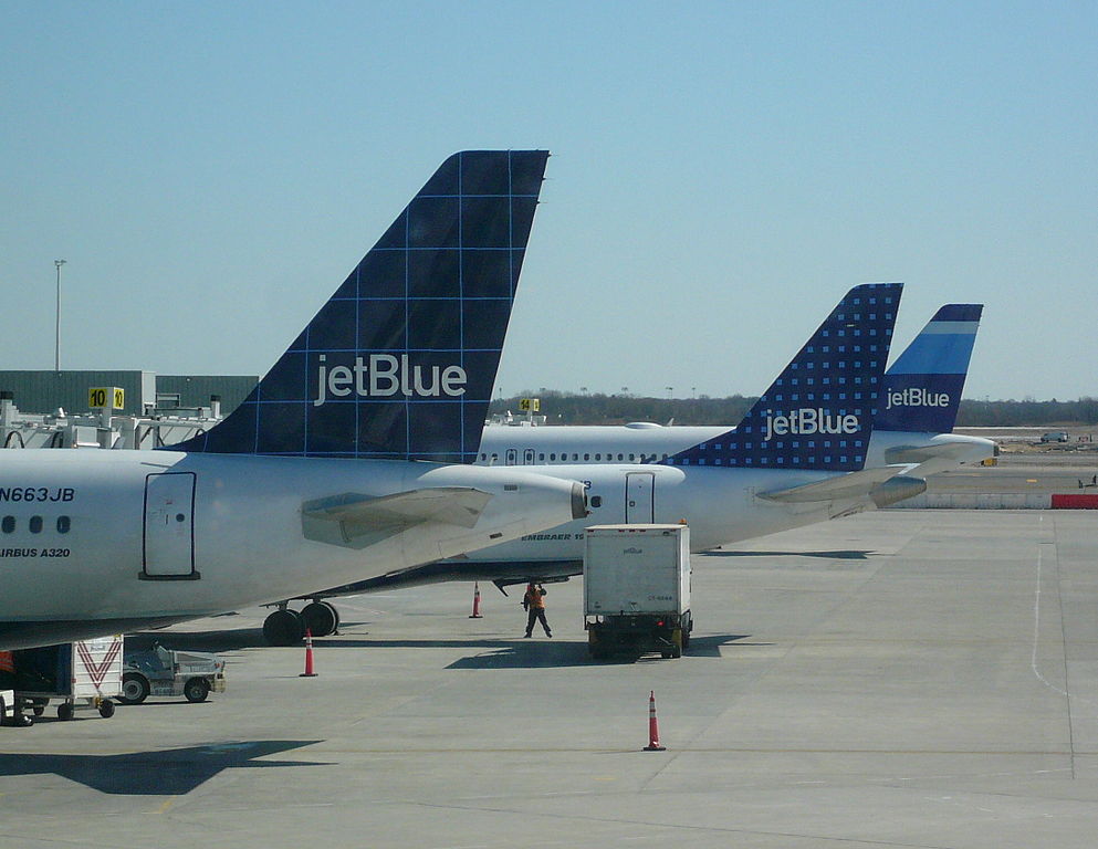 a group of airplanes parked at an airport