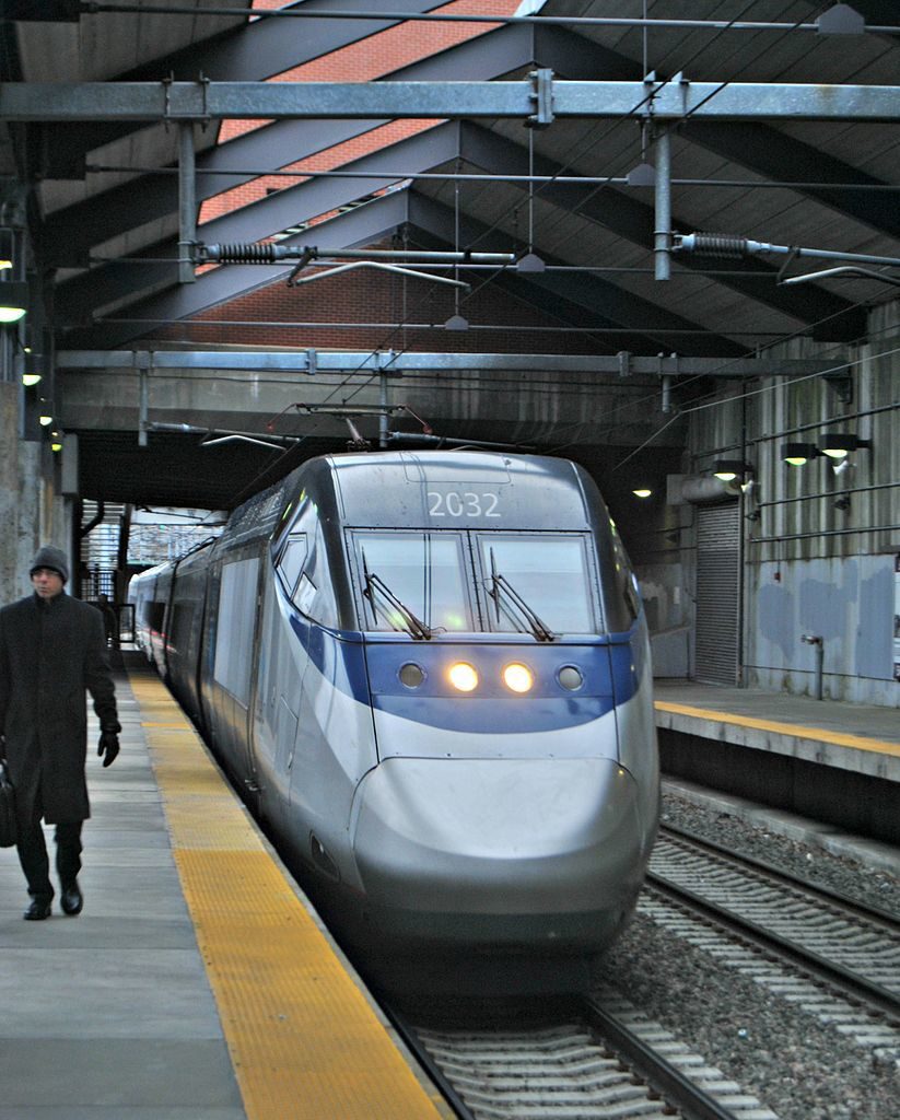 a man walking next to a train