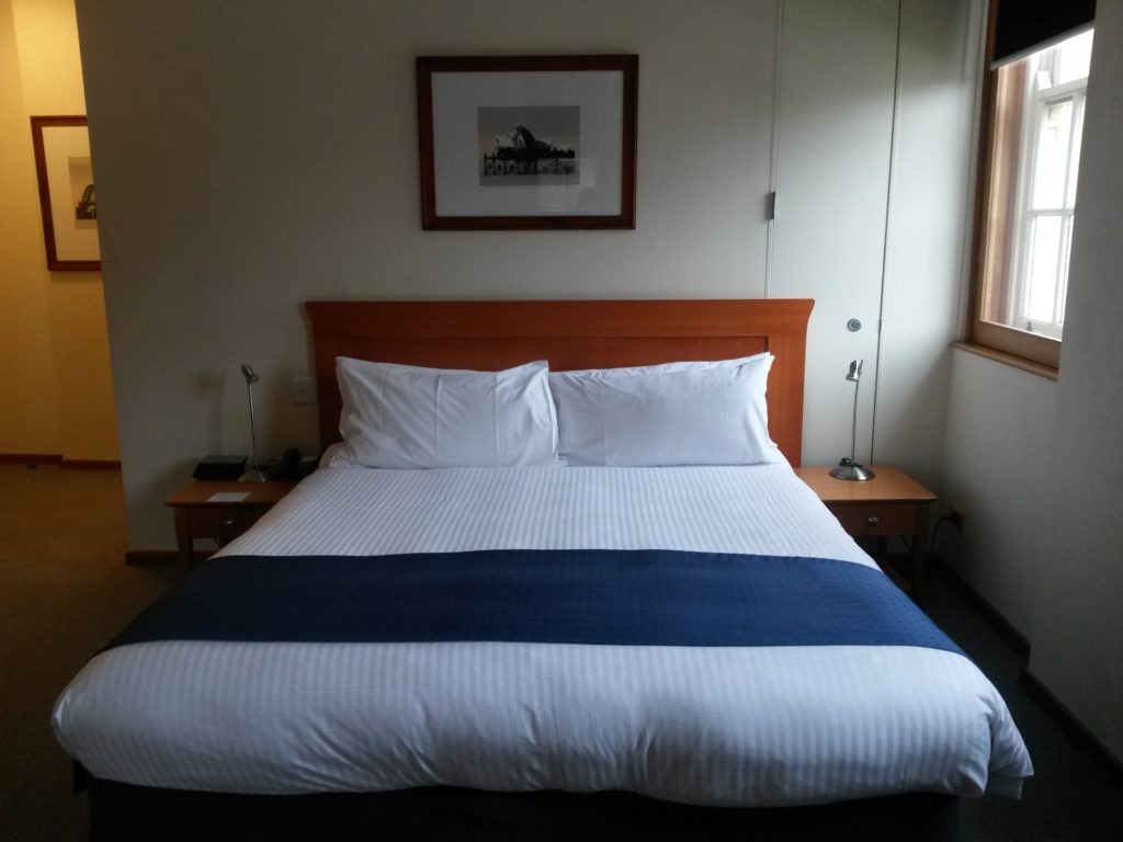 a bed with a blue and white striped blanket