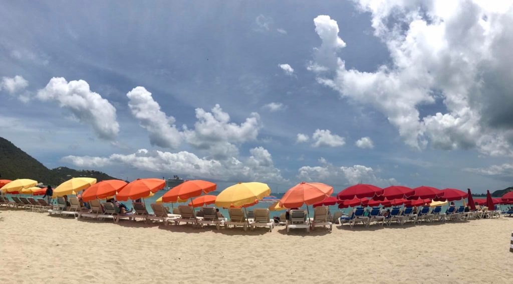 a group of chairs and umbrellas on a beach
