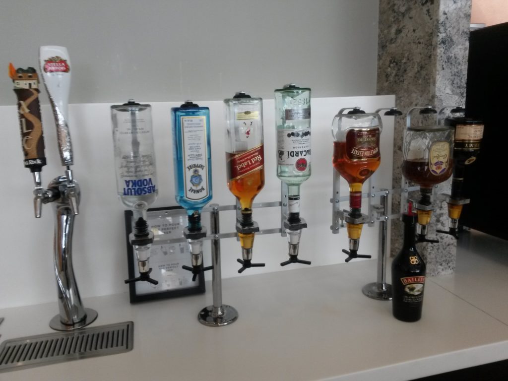 a group of liquor dispensers on a counter