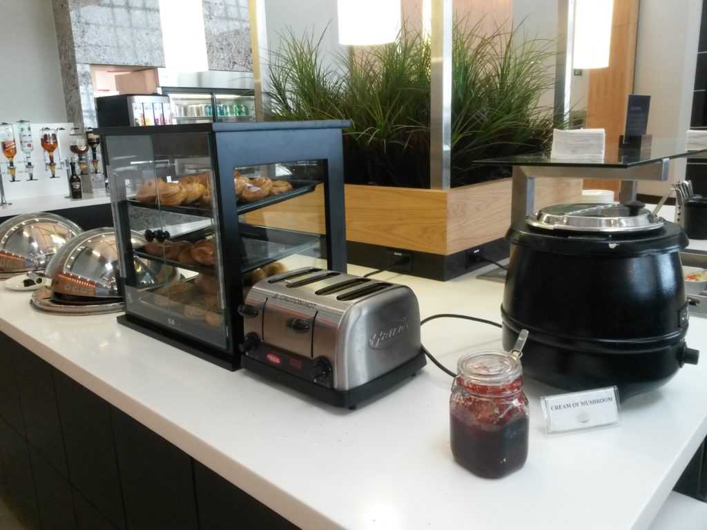a bread toaster and jam on a counter