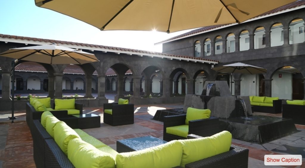 a patio area with chairs and umbrellas