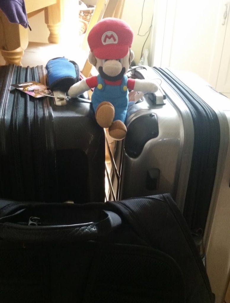 a stuffed toy sitting on top of luggage