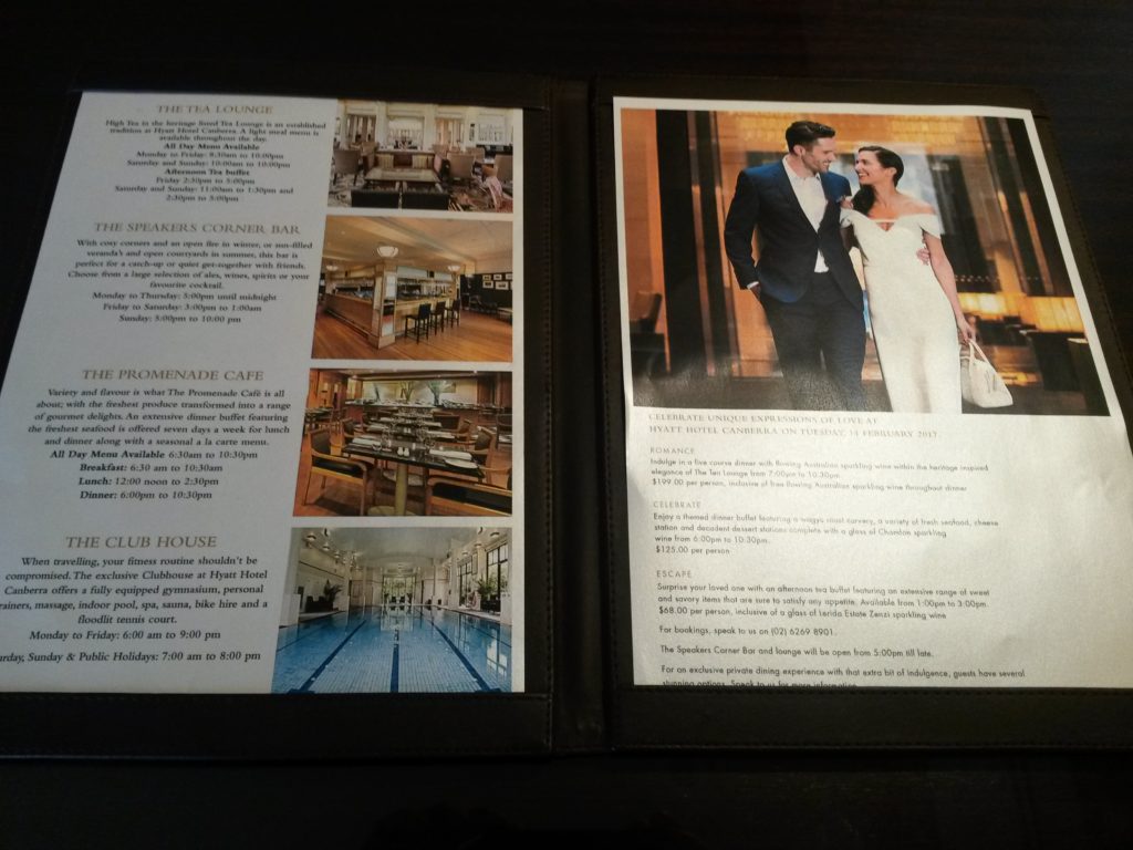 a menu with pictures of a couple in a restaurant