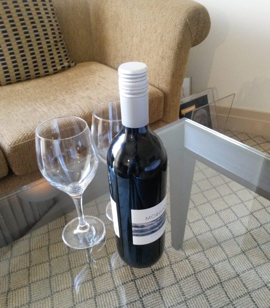 a bottle of wine and two wine glasses on a table