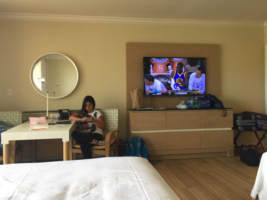 a woman sitting in a chair in front of a television