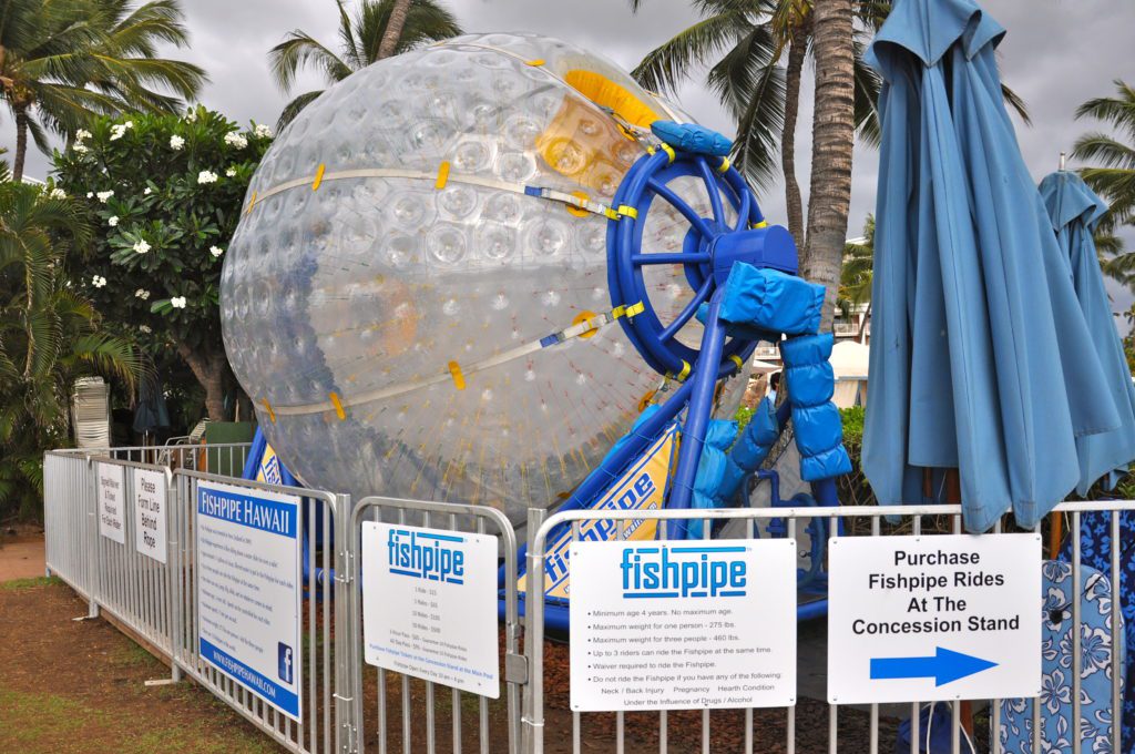 a large inflatable ball in front of a fence