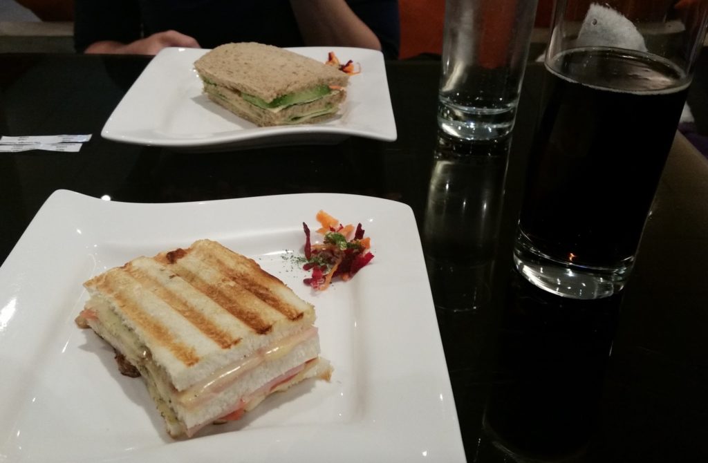 two plates of sandwiches on a table