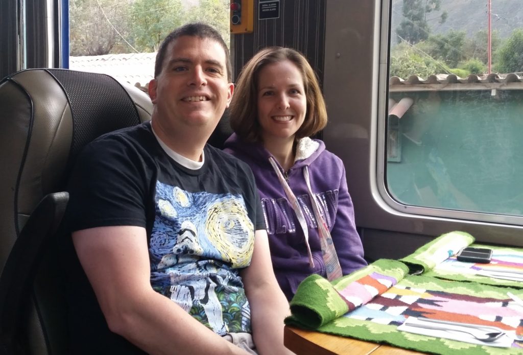 a man and woman sitting in a train