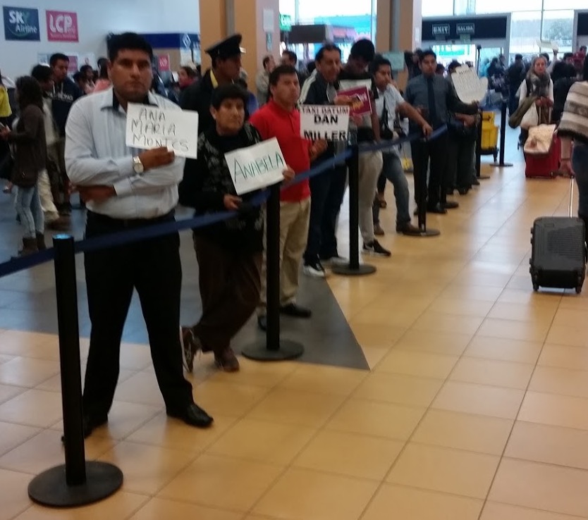 a group of people standing in a line with signs