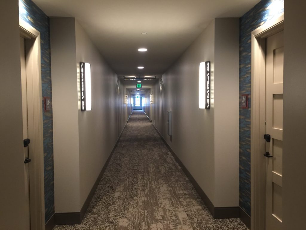 a hallway with lights on the wall