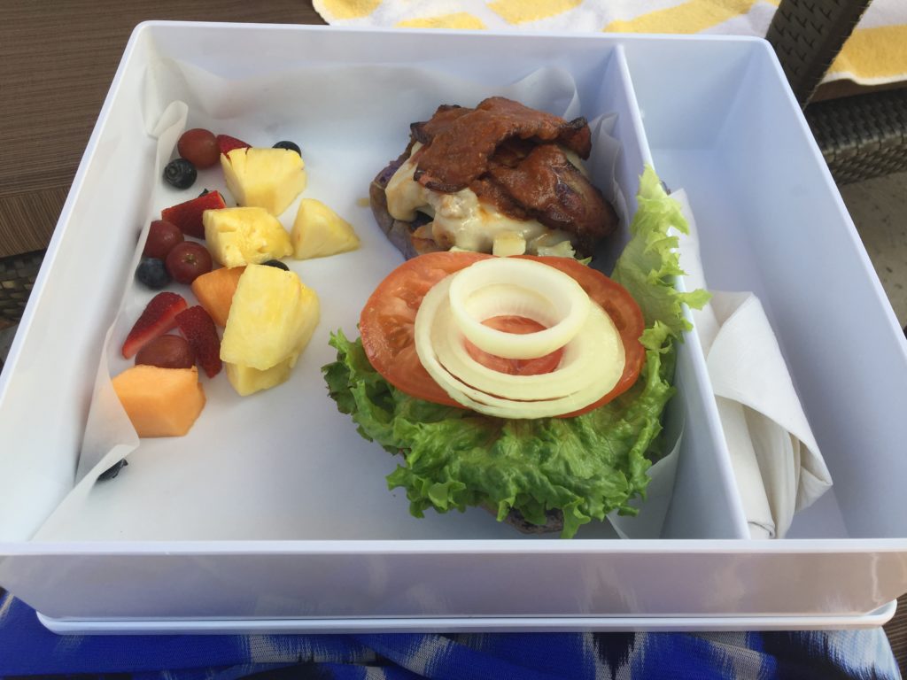 a tray of food with a sandwich and fruit