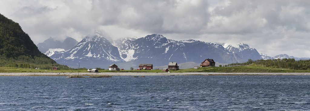 a group of houses by a body of water