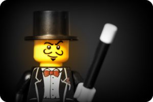 a toy figurine with a black top hat and a black wand