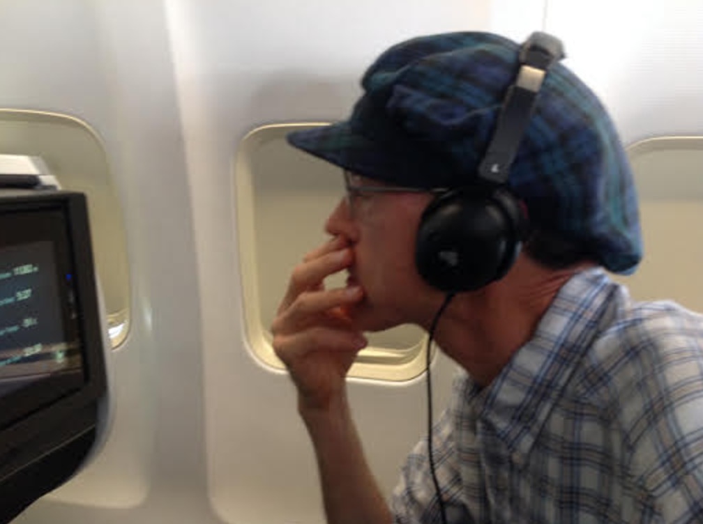 a man wearing headphones and holding his hand to his mouth