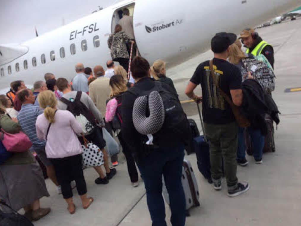 a group of people boarding an airplane