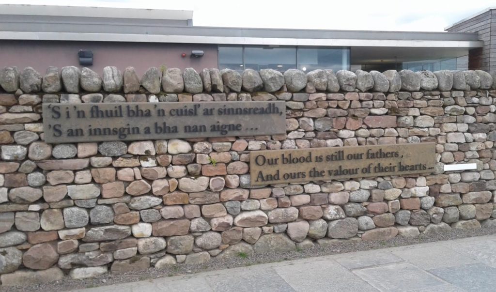 a stone wall with a sign