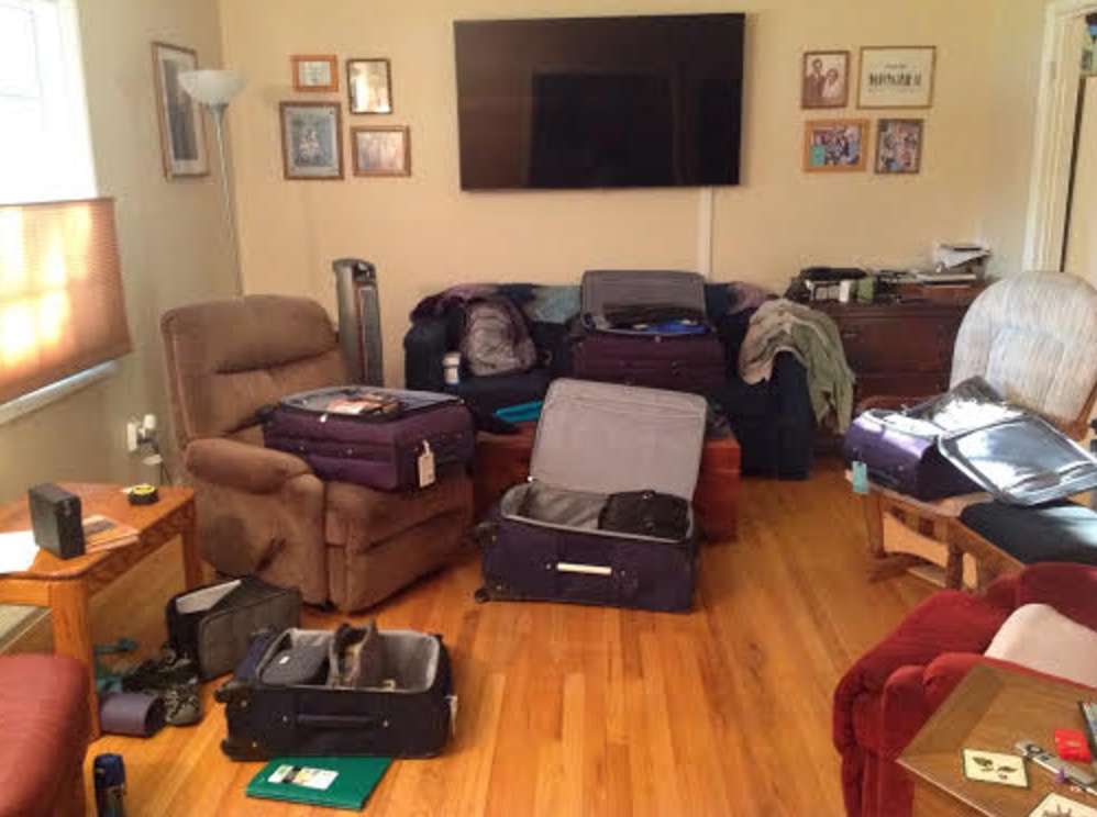 a room with a television and suitcases