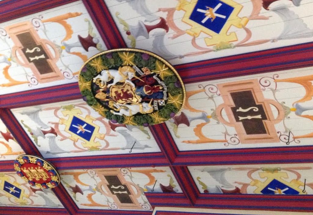 a colorful ceiling with a shield and horses on it