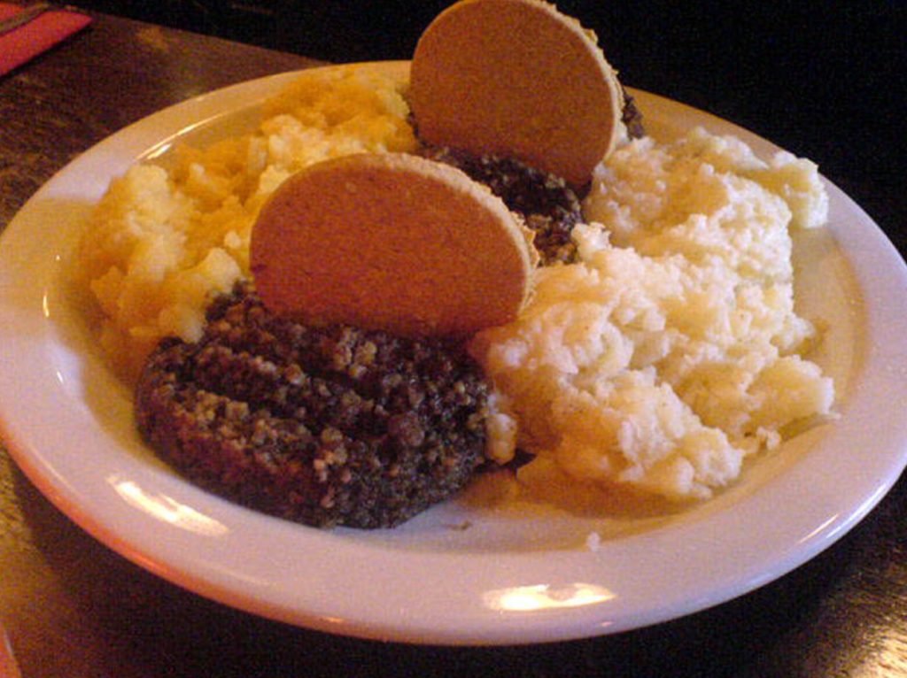 a plate of food with crackers and mashed potatoes