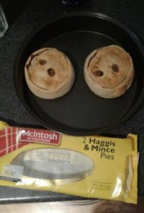 food in a pan next to a package