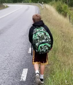 a boy walking on a road