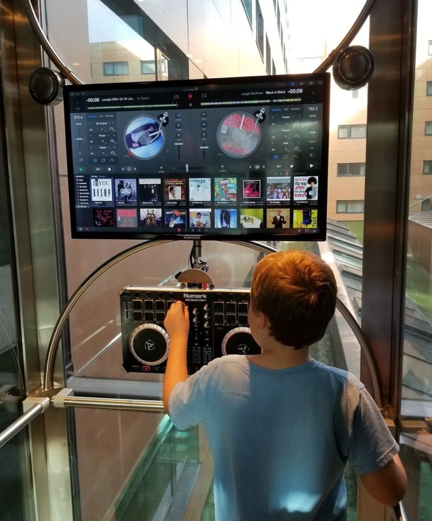 a boy playing music on a machine