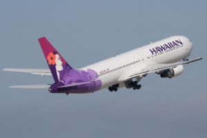 a white airplane with purple and white tail and purple logo