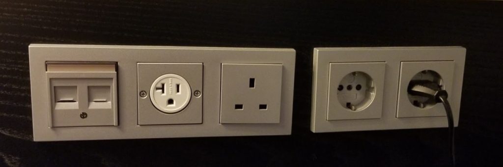 a wall outlet with a white outlet and a black wall