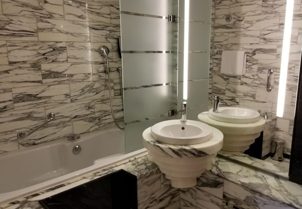 a bathroom with marble walls and sink