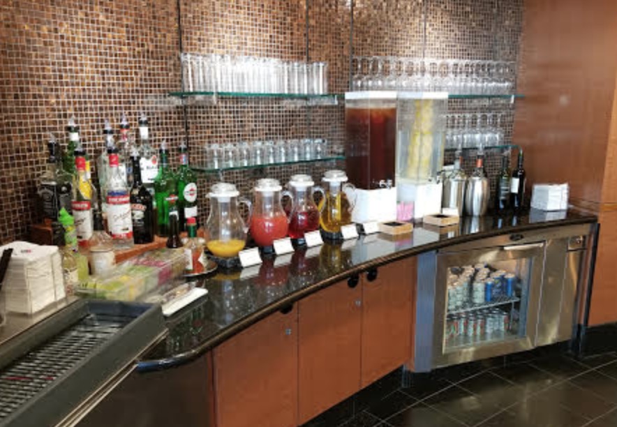 a bar with bottles of liquid and drinks