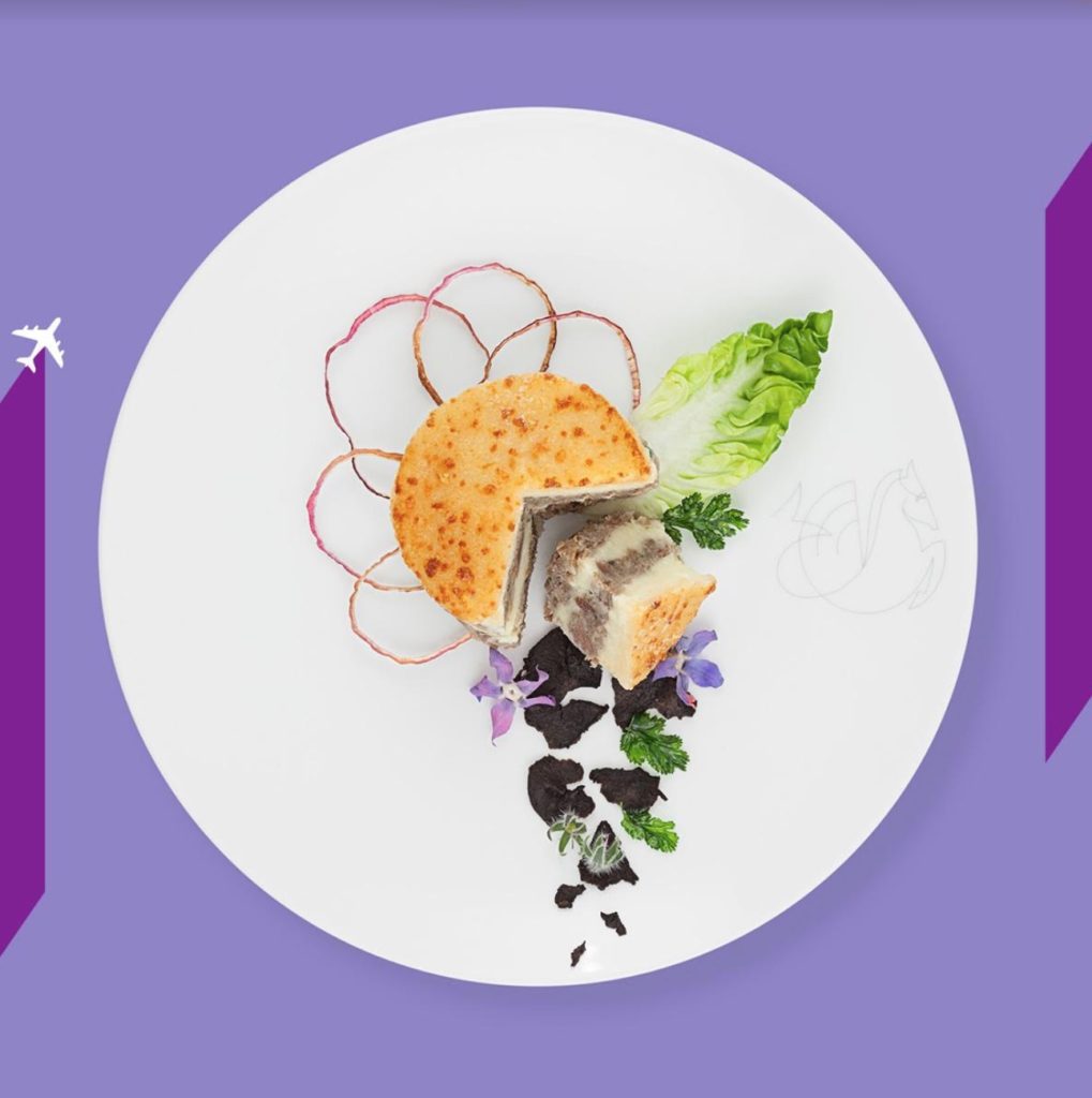 a plate of food on a purple background