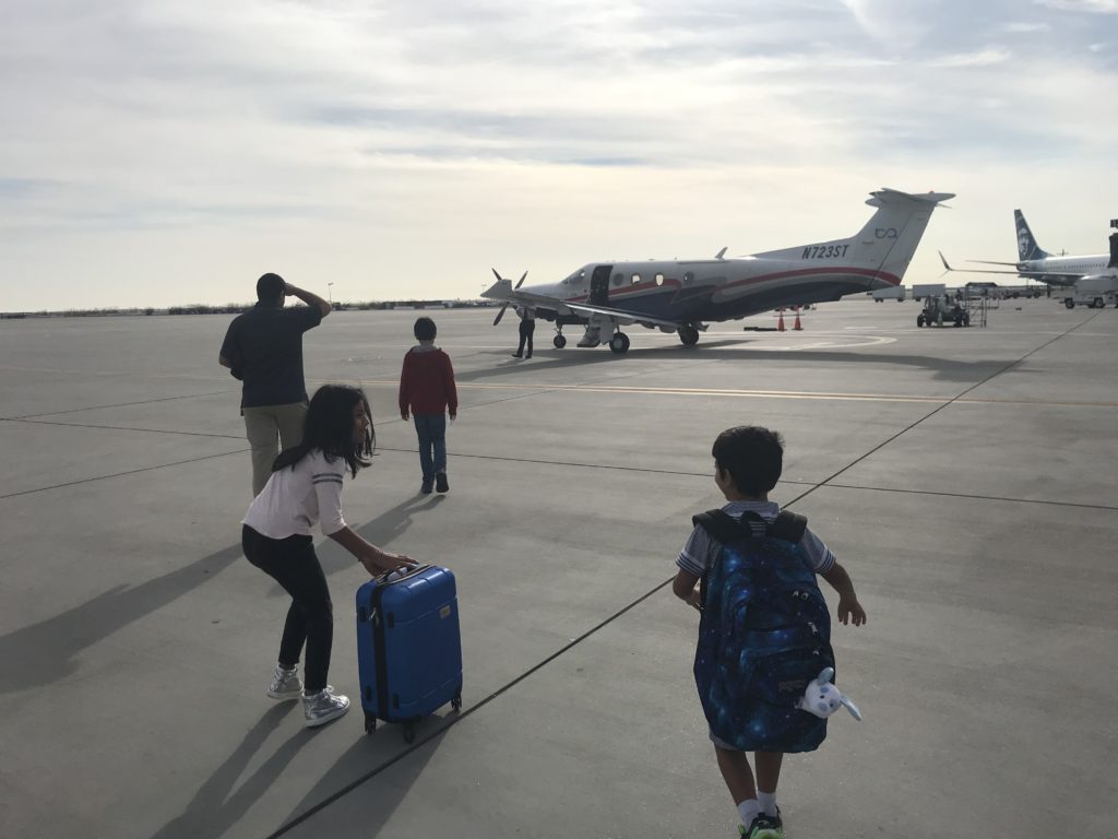 a group of children and a plane