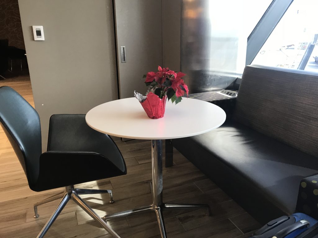 a table with a red potted plant on it